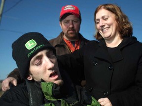 The Chauvins, Cathy, left, Joe, 17, and Maurice, go for a walk at their home in Stoney Point, Monday, March 14, 2013.  Joe Chauvin, who suffers from cerebral palsy, will have his funding cut when he turns 18.  The funding provides Chauvin with a support worker 2 times a week.  (DAX MELMER/The Windsor Star)