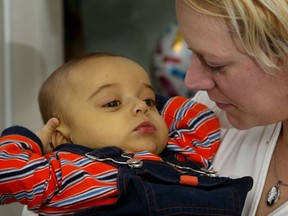 This file photo shows Kaidyn Blair, in the arms of his mother Tammy Griffiths, before he received the organ donation that saved his life. Now, he's paying that generosity forward. (Nick Brancaccio/The Windsor Star)