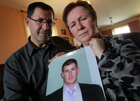 Aqif (left) and Shkendije Lluhani hold a photo of their deceased son Sharri Lluhani at their home in Windsor on Wednesday, March 20, 2013. The driver of the car that Lluhani was riding in when he was killed, Stephanie Bravo, was just sentenced today to 1 year in jail.                         (TYLER BROWNBRIDGE/The Windsor Star)