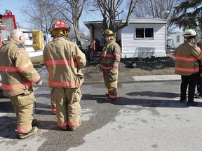 Essex firefighters investigate the scene of a mobile home fire Monday, March 4, 2013, at the Viscount Estate in Essex, Ont.    (DAN JANISSE/The Windsor Star)
