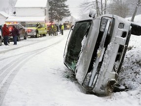 A Chevrolet Blazer went into a ditch and rolled onto its passenger side on a snow-covered Cherry Street in Rockefeller Township, Northumberland County, Pa. on Monday, March 18, 2013. A mother and daughter escaped injury State police at Stonington did not provide any additional information. (AP Photo/The News-Item, Larry Deklinski)