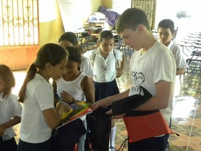 Braeden Seifarth (Grade 8 student at FLCA) distributing school supplies at Christ the King Lutheran Church in Chinandega, Nicaragua. (Handout)