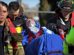 Windsor firefighters, Essex-Windsor EMS paramedics and area fishermen assist a man who fell into water of Detroit River while fishing from a boat dock near Lakeview Park Marina Friday March 8, 2013. (NICK BRANCACCIO/The Windsor Star)