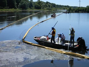 A sign at the confluence of Talmadge Creek and the Kalamazoo River warns residents of Marshall, Michigan. On July 26, 2010, hundreds of thousands of gallons of oil from a ruptured pipeline operated by Enbridge Inc. spilled into the Kalamazoo. (Sheldon Alberts / Postmedia News)