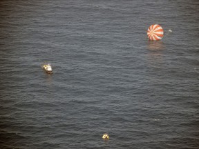 In this image provided by SpaceX, recovery boats approach the Dragon capsule after splashdown in the Pacific Ocean off the coast of Mexico's Baja Peninsula. The vehicle brought back more than 1 ton of science experiments and old equipment from the International Space Station. It's the only supply ship capable of two-way delivery. NASA is paying SpaceX more than $1 billion for a dozen resupply missions. (AP Photo/SpaceX)