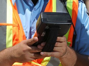File photo of a by-law enforcement officer at Commissionaires Parking Enforcement in Windsor, Ont., (Windsor Star files)