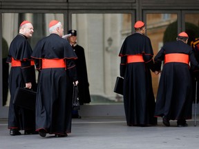 Cardinal Gianfranco Ravasi, left, arrives for a meeting at the Vatican, Friday, March 8, 2013. The last cardinal who will participate in the conclave to elect the next pope arrived in Rome on Thursday, meaning a date can now be set for the election. One U.S. cardinal said a decision on the start date is expected soon. (AP Photo/Alessandra Tarantino)