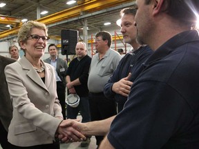 Premier Kathleen Wynne speaks with employees at Centreline LTD in Windsor, Ont. on Mar. 11, 2013. (Dan Janisse / The Windsor Star)