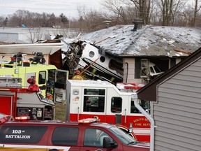 The front end of a Hawker Beachcraft Premier jet sits in a room of a home on Iowa Street in South Bend, Ind., Sunday, March 17, 2013. Authorities say a private jet apparently experiencing mechanical trouble crashed resulting in injuries. Federal Aviation Administration spokesman Roland Herwig says the Beechcraft Premier I twin-jet had left Tulsa, Okla.'s Riverside Airport and crashed near the South Bend Regional Airport on Sunday afternoon. (AP Photo/South Bend Tribune, Mike Hartman)