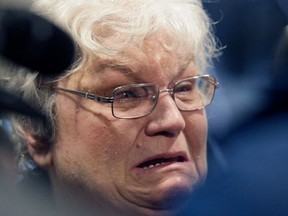 A tearful Carol Beasley, mother of convicted murderer Richard Beasley, talks to reporters upon leaving the Summit County Courthouse on Tuesday, March 12, 2013, in Akron, Ohio. Richard Beasley was found guilty with aggravated murder in the killing two men from Ohio and one from Norfolk, Va. by luring them with Craigslist job offers. (AP Photo/Akron Beacon Journal, Phil Masturzo, Pool)