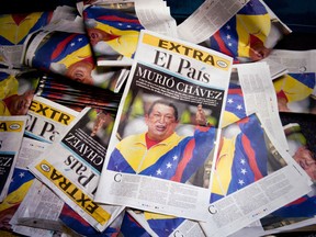 View of newspapers announcing the death of Venezuelan President Hugo Chavez, on March 5, 2013, in Cali, department of Valle del Cauca, Colombia. Chavez lost his battle with cancer, silencing the leading voice of the Latin American left and plunging his divided oil-rich nation into an uncertain future..AFP PHOTO / LUIS ROBAYO