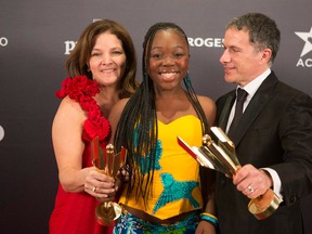 Rachel Mwanza, centre, stands with producers Marie-Claude Poulin, left, and Pierre Even as they celebrate their Best Actress and Best Film Award for "Rebelle/War Witch" at the Canadian Screen Awards in Toronto on Sunday, March 3, 2013. THE CANADIAN PRESS/Chris Young