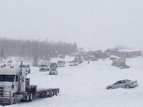Vehicles litter Highway 2 near Leduc, Alta. on Thursday March 21, 2013. A blizzard that has been blasting through the Prairies is being blamed for a multi-vehicle crash south of Edmonton that has injured about 100 people. THE CANADIAN PRESS/Stephanie Williams
