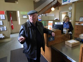 Alistair MacLeod drops off packages at the Canada Post office at Sandwich  and Mill streets in Windsor, Ontario on March 26, 2013.  The historic post office will close April 26. (JASON KRYK/The Windsor Star)