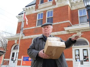 Alistair MacLeod drops off packages at the Canada Post office at Sandwich  and Mill streets in Windsor, Ontario on March 26, 2013.  The historic post office will close April 26. (JASON KRYK/The Windsor Star)
