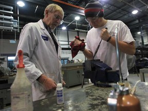 St. Clair College industrial mechanic professor Kevin Hodson, left, instructs student Arron Backhouse, 20,  at the St. Clair College Ford Centre for Excellence in Windsor, Ontario on March 20, 2013.  (JASON KRYK/ The Windsor Star)