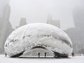 The sculpture "Cloud Gate", commonly known as "the bean," is covered in snow on March 5, 2013 in Chicago, Illinois. The worst winter storm of the season is expected to dump 7-10 inches of snow on the Chicago area with the worst expected for the evening commute. (Photo by Brian Kersey/Getty Images)