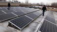 OYA Solar Inc. system designers Giovanni Cristofanilli, right, and Matthew Marentette inspect part of their roof-top Feed-in-Tariff (FIT) project installed on a Peter Street plant, March 6, 2013. (NICK BRANCACCIO/The Windsor Star)