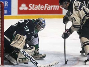 Windsor's Remy Giftopoulos battles for the puck in front of Plymouth goalie, Matt Mahalak, left, as the Windsor Spitfires host the Plymouth Whalers at the WFCU Centre, Sunday, March 17, 2013.  (DAX MELMER/The Windsor Star)