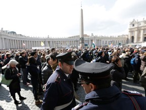 In this file photo taken on Feb. 24, 2013, policeman patrol as faithful gather the last Angelus noon prayer of Pope Benedict XVI, celebrated from the window of his studio overlooking St. Peter's square at the Vatican. Planning for the moment when the next pope is proclaimed to the world, and for the installation ceremony a few days later, is a big-time guessing game. And that adds up to an ungodly logistical headache for the city of Rome. Nearly everything went smoothly for Benedict’s last public appearances, although some faithful panicked during the retired pope’s penultimate Sunday blessing from his studio window, when thousands of last-minute arrivals tried to squeeze through three narrow openings through a metal fence ringing the edge of the square. (AP Photo/Alessandra Tarantino)
