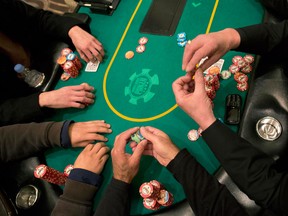 Poker players cast their bets during a hand of Texas Hold 'em at the poker room at Caesar's Palace, Wednesday, Feb. 27, 2013, in Las Vegas. Poker has never been a big moneymaker like slot machines or roulette. In Sin City, epicenter of the poker craze, at least eight rooms have folded in the past two years. The trend is also playing out in Mississippi riverboats, Indian casinos and gambling halls near big cities from California to Florida. (AP Photo/Julie Jacobson)