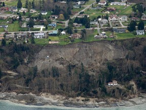 An aerial photo shows a landslide near Coupeville, Wash. on Whidbey Island, Wednesday, March 27, 2013. The slide severely damaged one home and isolated or threatened more than 30 on the island, about 50 miles north of Seattle in Puget Sound. No one was reported injured in the slide, which happened at about 4 a.m. Wednesday. (AP Photo/Ted S. Warren)