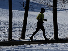 In this file photo, a runner is silhouetted against the white snow as they make their way through Malden Park in Windsor. (TYLER BROWNBRIDGE / The Windsor Star)