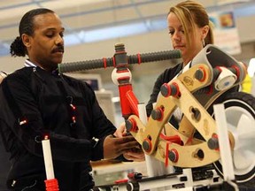 Ken Bryant assembles a bike with the help of instructor Wendy Santure at the World Class Manufacturing Academy are pictured in Warren, Michigan on Friday, March 1, 2013. Employees from across the Chrysler company come to the facility to train and work on real world problems.                   (TYLER BROWNBRIDGE / The Windsor Star)