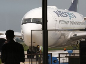 A WestJet plane rolls into the Windsor International Airport in Windsor, Ont. on Friday, Sept. 7, 2012. (DAN JANISSE/ The Windsor Star)