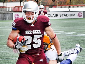 GG quarterback Aaron Colbon is sacked by Akeem Whonder in the second half as the Ottawa University GG's meet the University of Windsor Lancers at Frank Clair Stadium October 29, 2011, in the Ontario University quarter final game. (Wayne Cuddington / Ottawa Citizen)