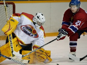 Kingsville goalie Jordan Shallow, left, makes a save on Belle River's Justin Brown in 2009. (Star file photo)