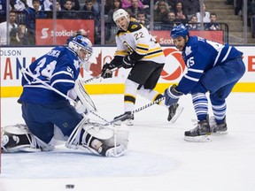 Toronto goaltender James Reimer, left, makes a save on Boston's Shawn Thornton with Mark Fraser back on the play in Toronto Saturday. (THE CANADIAN PRESS/Chris Young)