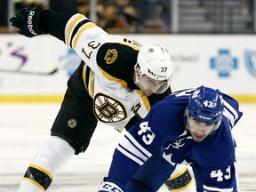 Toronto's Nazem Kadri, right, is checked by Boston's Patrice Bergeron Monday. (AP Photo/Winslow Townson)