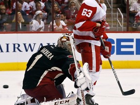 Phoenix goalie Jason LaBarbera, left, ives up a goal to Detroit's Ian White with Joakim Andersson, right, setting the screen Monday in Glendale, Ariz. (AP Photo/Ross D. Franklin)