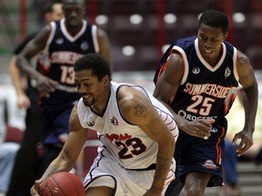 Windsor's Mike Helm, left, takes the ball up court against Summerside's Aykodokum Akinbade at WFCU Centre. (NICK BRANCACCIO/The Windsor Star)
