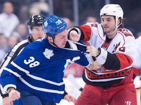 In this file photo, Amherstburg's Kevin Westgarth, right, fights Toronto's Frazer McLaren Thursday, March 28, 2013, in Toronto. (THE CANADIAN PRESS/Nathan Denette)
