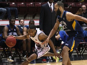 Windsor's Darren Duncan, left, cuts around Saint John's Kevin Francis at the WFCU Centre. (DAN JANISSE/The Windsor Star)