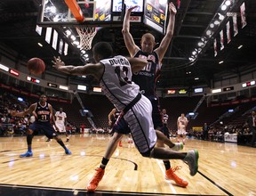 Windsor's Darren Duncan, left, tries to pass the ball while falling out of bounds agaisnt Summerside's Nick Evans in Game 4 of their playoff series at the WFCU Centre Saturday. (DAX MELMER/The Windsor Star)