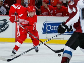 Detroit's Pavel Datsyuk, left, controls the puck in front of Windsor native Ryan Wilson of the Avalanche at Joe Louis Arena. (Photo by Gregory Shamus/Getty Images)