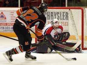 Dylan Solicki, left, fires a shot on Wheatley goalie Marc Tremblay at Essex Arena. (TYLER BROWNBRIDGE / The Windsor Star)