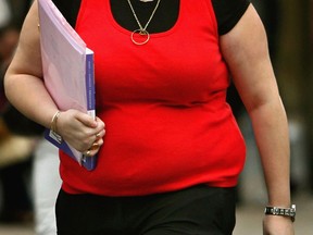 An obese woman walks down the street in Scotland. (Getty Images files)