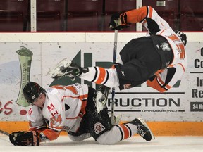 Essex teammates Daniel Slipchuck, left, and Colin Moore get tripped up during their game Tuesday, March 19, 2013, at Essex Arena against the Ayr Centennials.   (DAN JANISSE/The Windsor Star)