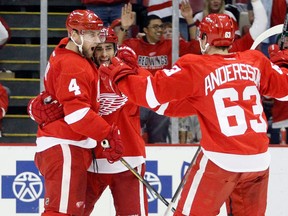 Detroit's Jakub Kindl, left, celebrates his goal with Niklas Kronwall, centre, and Joakim Andersson at Joe Louis Arena. (AP Photo/Duane Burleson)