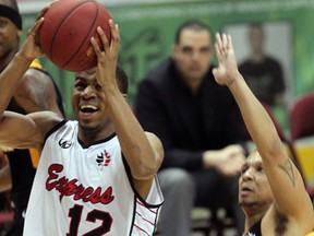 Windsor's Darren Duncan, left, rives the lane in front of London's Adrian Moss at the WFCU Centre.  (NICK BRANCACCIO/The Windsor Star)