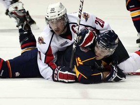 Former Spitfires captain Adrian Robertson, top, draws a minor penalty against Barrie's Mark Scheifele last season at theWFCU Centre. Robertson, along with ex-Spits defenceman Ben Shutron, are playing for the New Brunswick Varsity Reds at the CIS championships in Saskatoon.  (NICK BRANCACCIO/The Windsor Star)