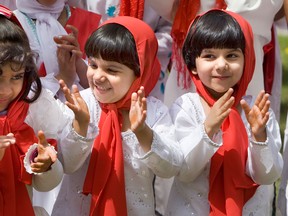 Ahmadiyya Muslim Community children clap loud and proudly after the Canada flag raising during Canada celebration in Saskatoon, July 1, 2010.  (Star Phoenix files)