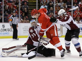 Detroit Red Wings right wing Daniel Cleary (11) rushes the net as the puck bounces off Colorado Avalanche goalie Jean-Sebastien Giguere's pad for a goal by Red Wings defenseman Niklas Kronwall during the second period of an NHL hockey game in Detroit, Tuesday, March 5, 2013. At right is Avalanche defenseman Shane O'Brien. (AP Photo/Carlos Osorio)