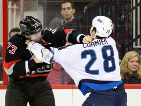 In this file photo, Winnipeg's Patrice Cormire, right, fights Windsor's Brett Bellemore of the Carolina Hurricanes during the first period at PNC Arena March 26, 2013 in Raleigh, N.C. (Grant Halverson/Getty Images)