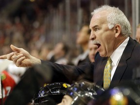 Chicago Blackhawks head coach Joel Quenneville yells to his team during the second period of an NHL hockey game against the Columbus Blue Jackets in Chicago, Friday, March 1, 2013. (AP Photo/Nam Y. Huh)