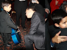 Jivan Ramesh, 4, of Windsor, shows famed cellist Yo-Yo Ma his cello following Ma’s concert at the University of Michigan last weekend. After Jivan played for Ma, the famed cellist offered him a congratulatory hug.